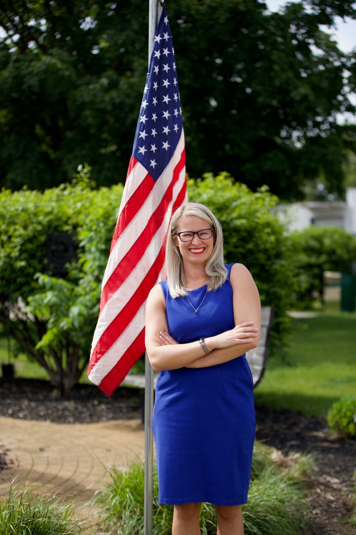 Jennifer Fields standing in front of an American flag