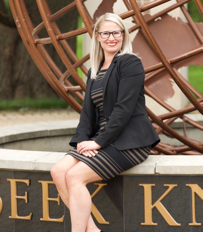 Jennifer Fields seated outdoors in professional attire
